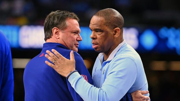 Apr 4, 2022; New Orleans, LA, USA; North Carolina Tar Heels head coach Hubert Davis hugs Kansas Jayhawks head coach Bill Self before the game during the 2022 NCAA men's basketball tournament Final Four championship game at Caesars Superdome.